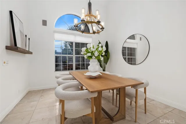 a view of a dining room with furniture and a chandelier