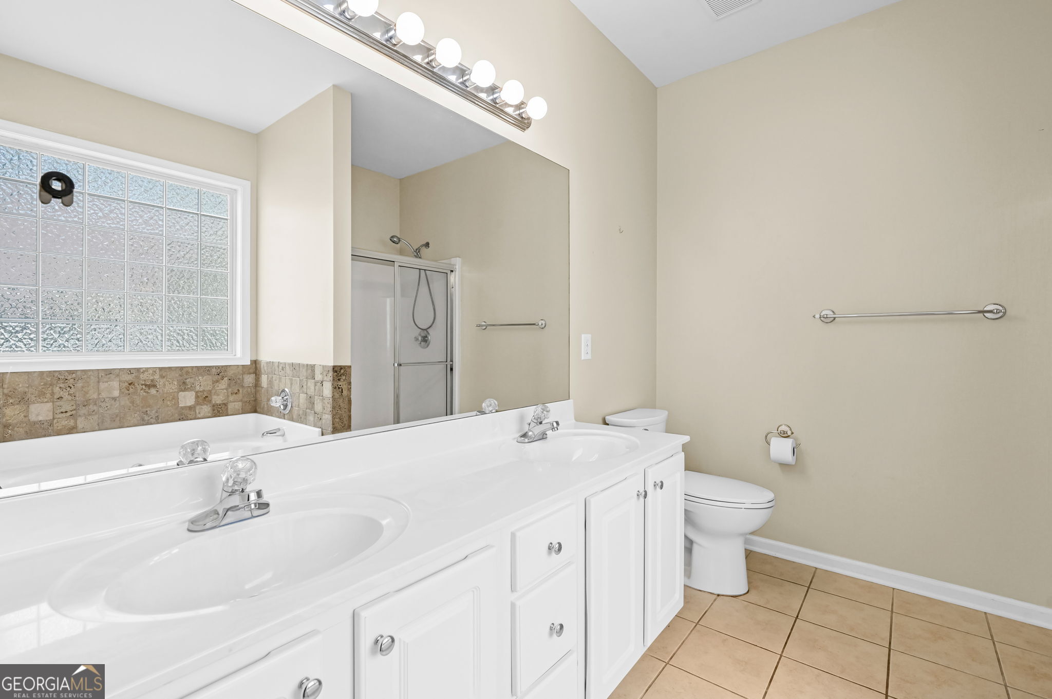 21 Verandah View Newnan, GA 30265 - Photo 18 of 39 a bathroom with a sink a toilet and a large mirror