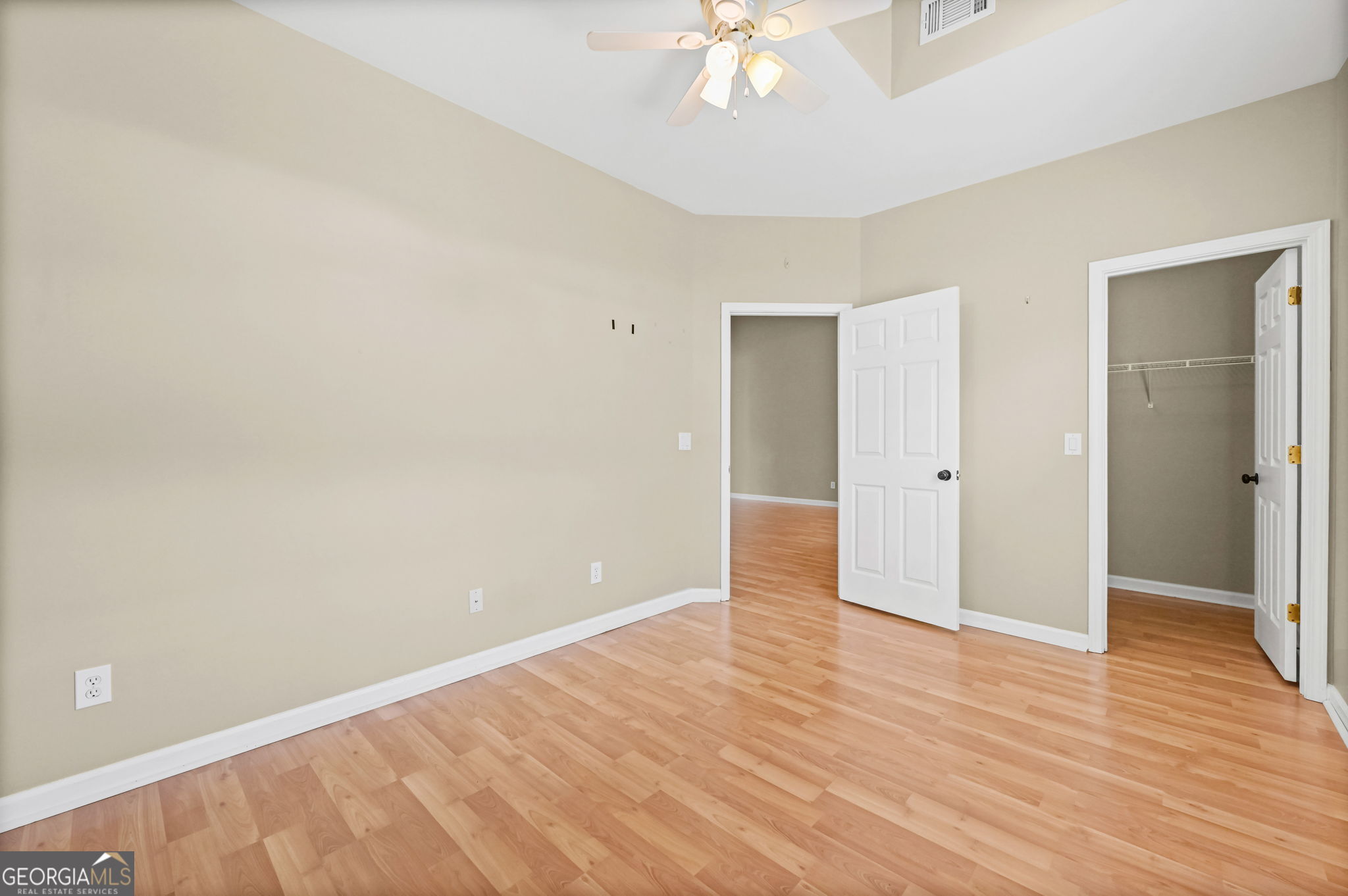 21 Verandah View Newnan, GA 30265 - Photo 26 of 39 an empty room with wooden floor and chandelier fan