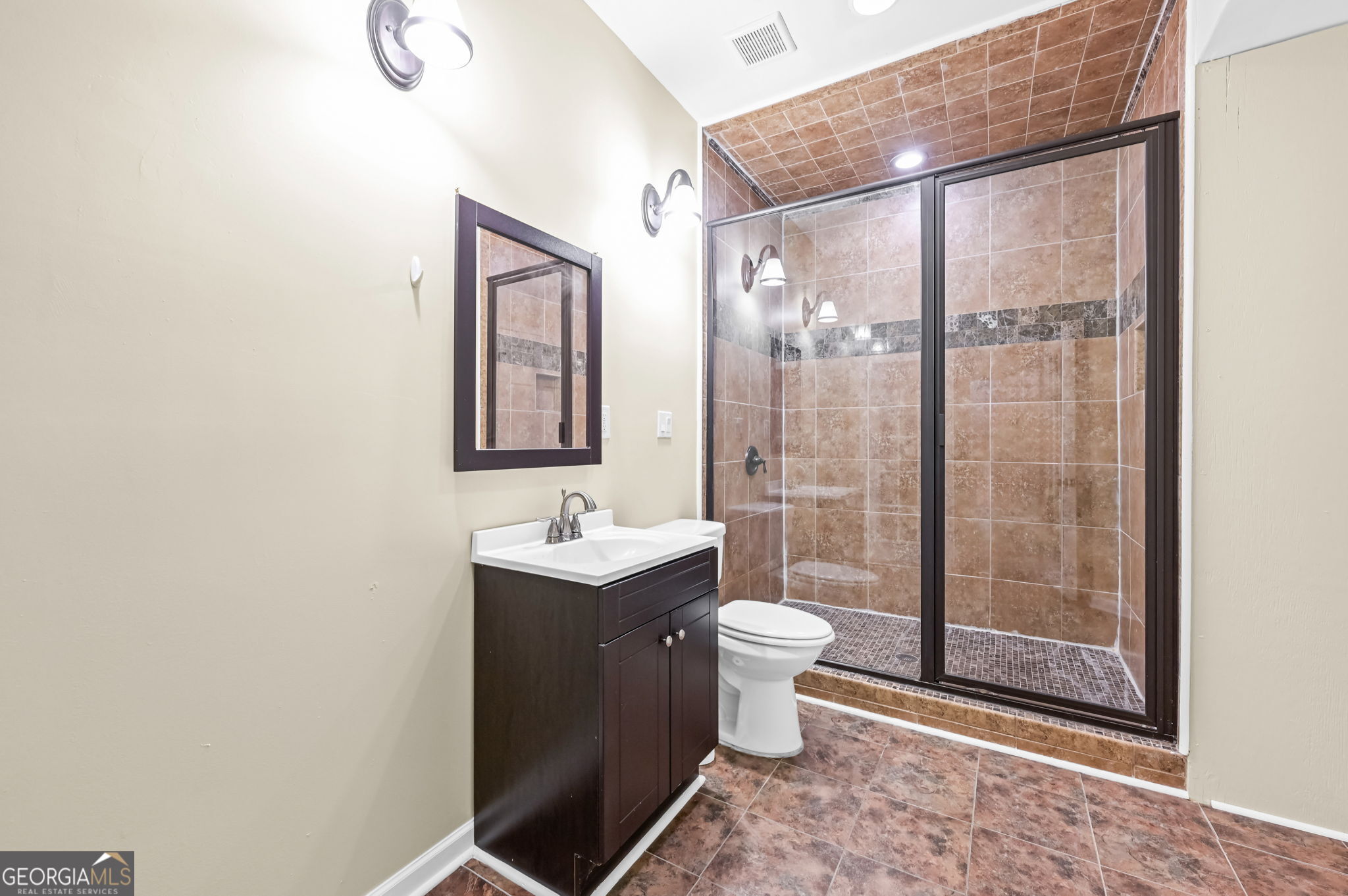 21 Verandah View Newnan, GA 30265 - Photo 29 of 39 a bathroom with a granite countertop sink toilet a mirror and shower