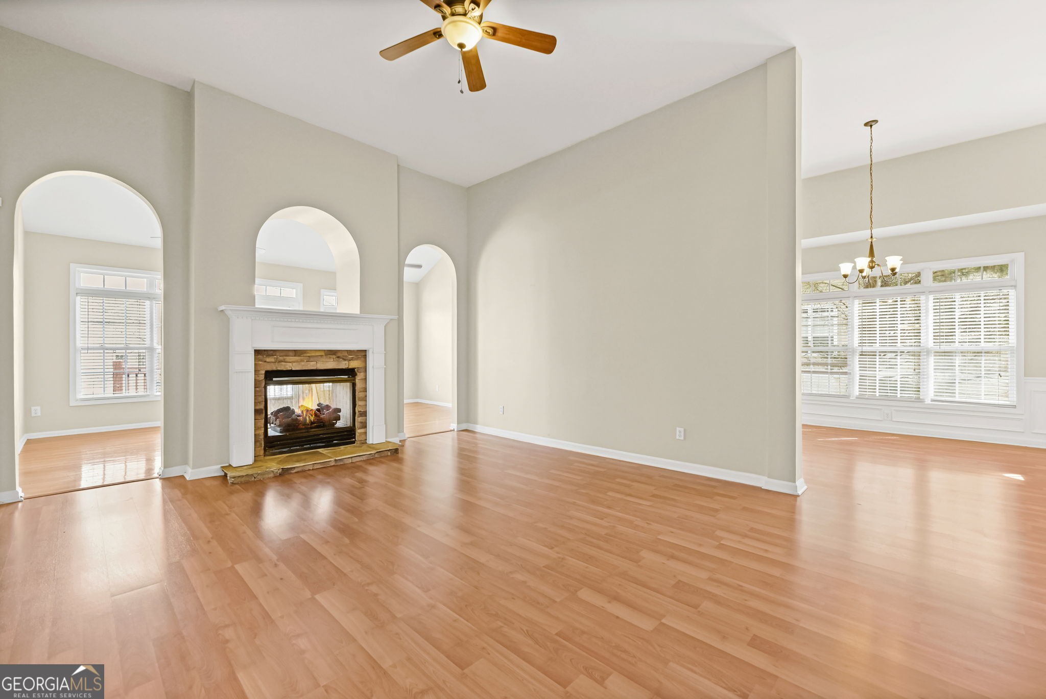 21 Verandah View Newnan, GA 30265 - Photo 8 of 39 an empty room with windows fireplace and wooden floor