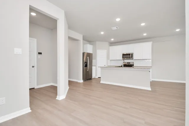 a view of a hallway with wooden floor