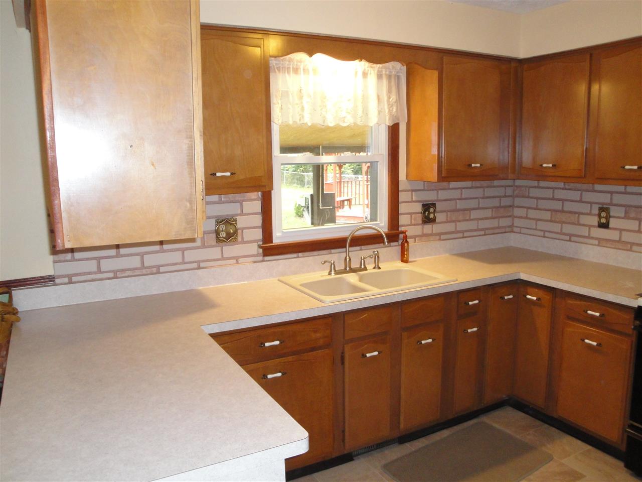 7155 Ralph Road Rockford, IL 61109 - Photo 4 of 18 a spacious bathroom with a granite countertop sink and a large mirror