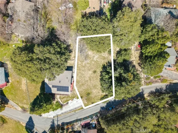 an aerial view of a residential houses with yard