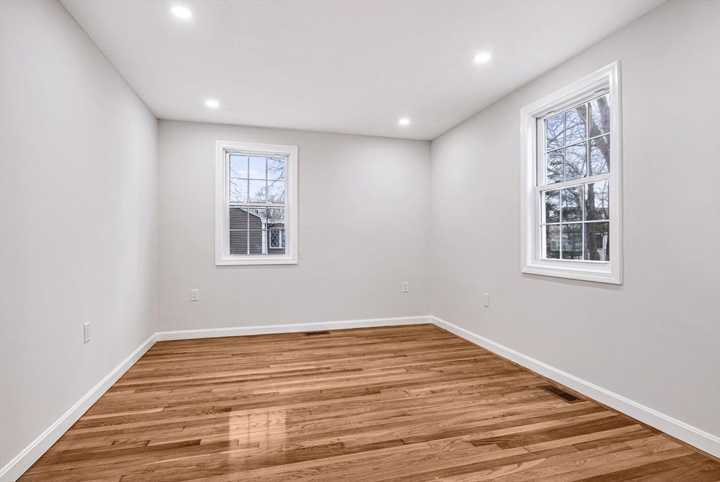 76 Sunset Drive Brockton, MA 02301 - Photo 13 of 32 a view of empty room with wooden floor and fan