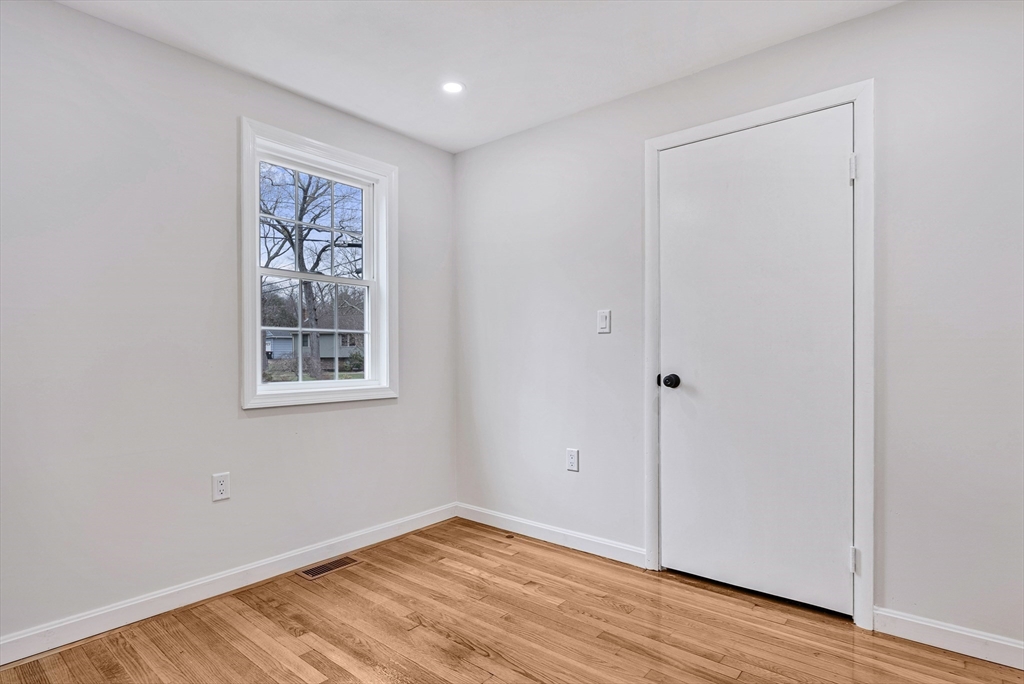 76 Sunset Drive Brockton, MA 02301 - Photo 14 of 32 an empty room with wooden floor and windows