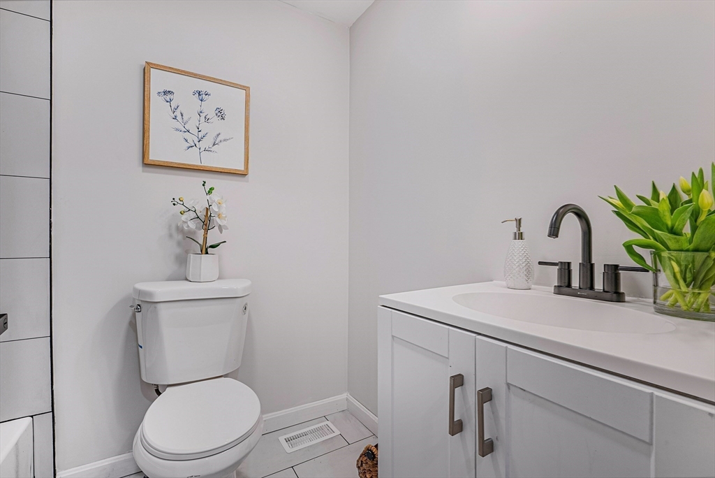 76 Sunset Drive Brockton, MA 02301 - Photo 15 of 32 a bathroom with a toilet sink and mirror