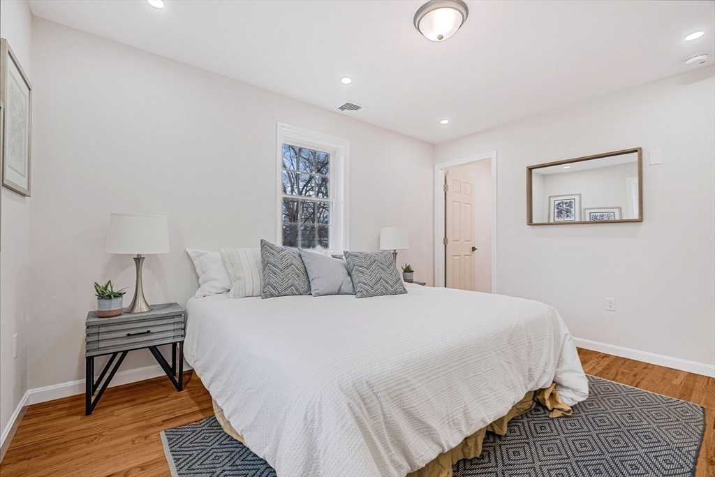 76 Sunset Drive Brockton, MA 02301 - Photo 25 of 32 a bedroom with a bed and wooden floor