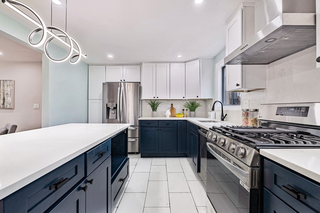 76 Sunset Drive Brockton, MA 02301 - Photo 5 of 32 a kitchen with stainless steel appliances a sink dishwasher stove refrigerator and cabinets