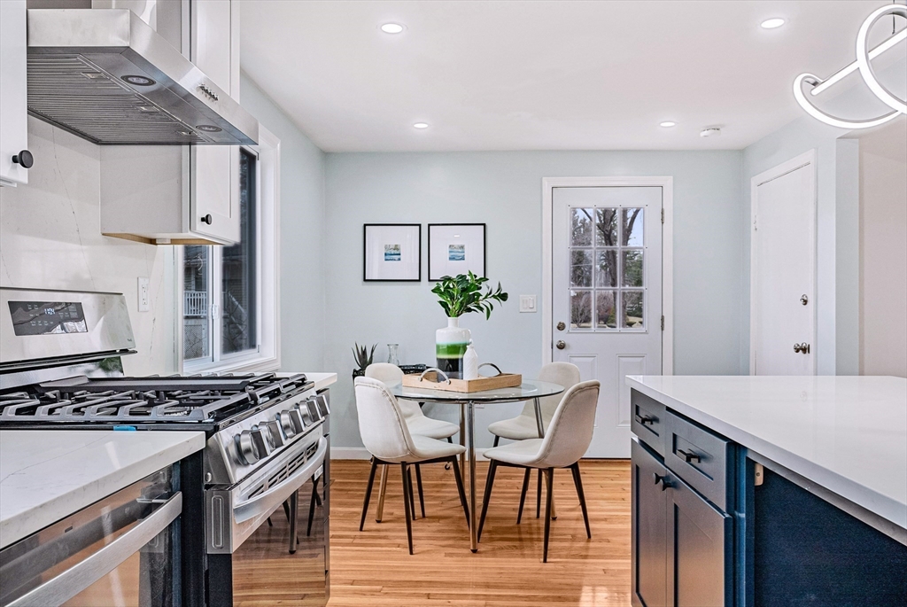 76 Sunset Drive Brockton, MA 02301 - Photo 9 of 32 a view of a kitchen area with furniture and wooden floor
