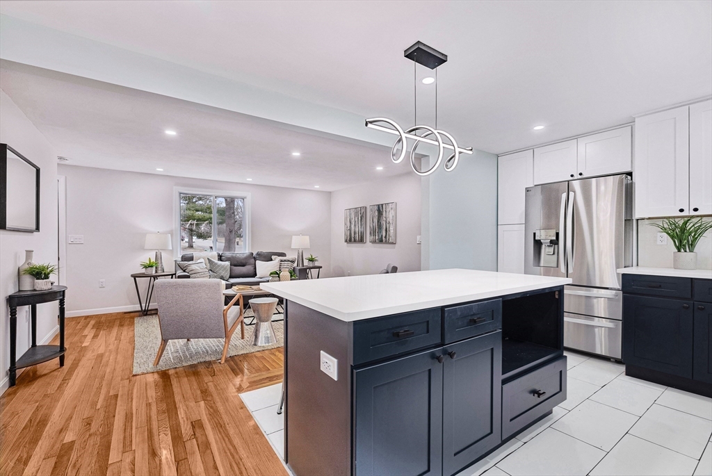 76 Sunset Drive Brockton, MA 02301 - Photo 10 of 32 a kitchen with kitchen island a counter top space a sink stainless steel appliances and cabinets