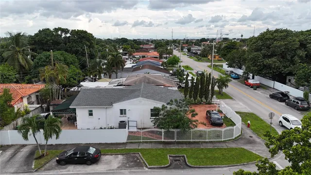 an aerial view of a house with garden space and ocean view