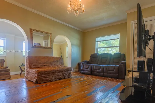 a living room with furniture and a chandelier