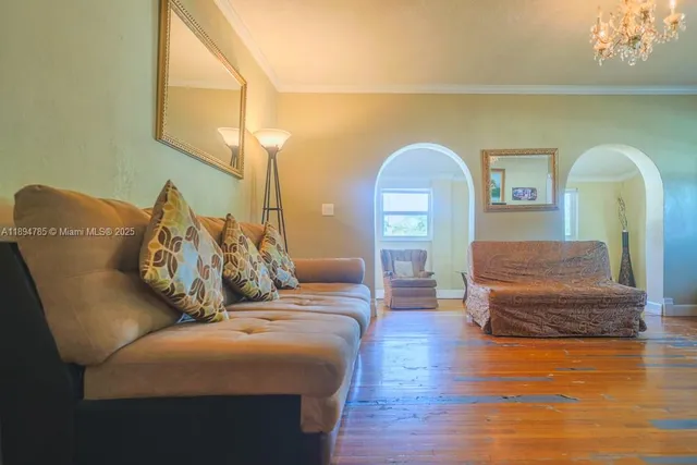 a living room with furniture and wooden floor
