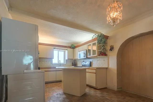 a kitchen with cabinets and window