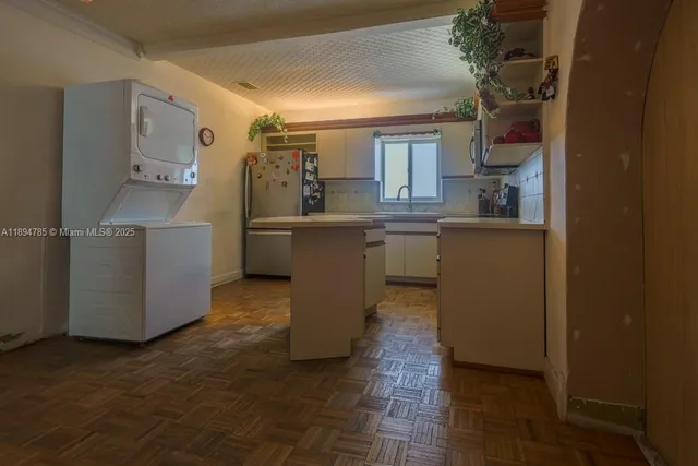 a bedroom with two beds and a large window