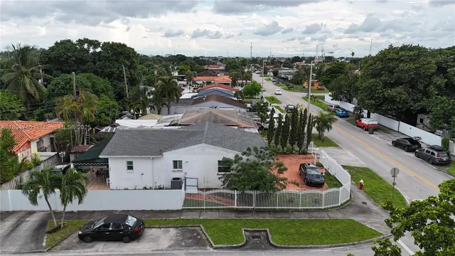 an aerial view of a house with garden space and street view