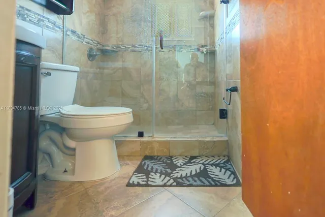 a kitchen with stainless steel appliances a sink cabinets and wooden floor