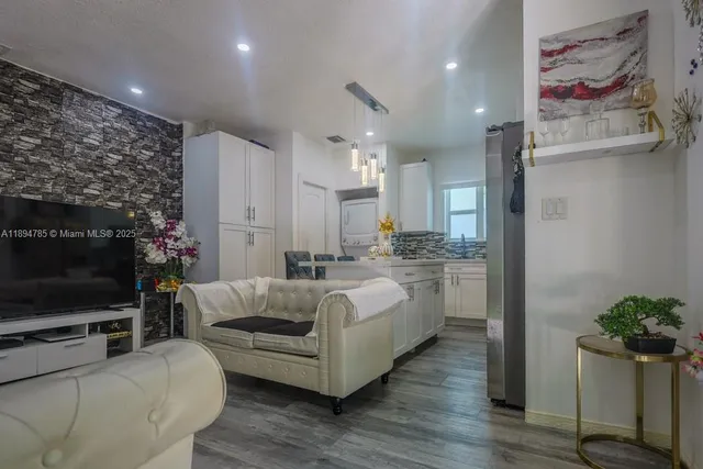 a kitchen with a table chairs sink and cabinets