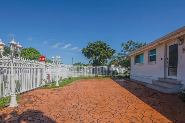 a view of a house with backyard and sitting area