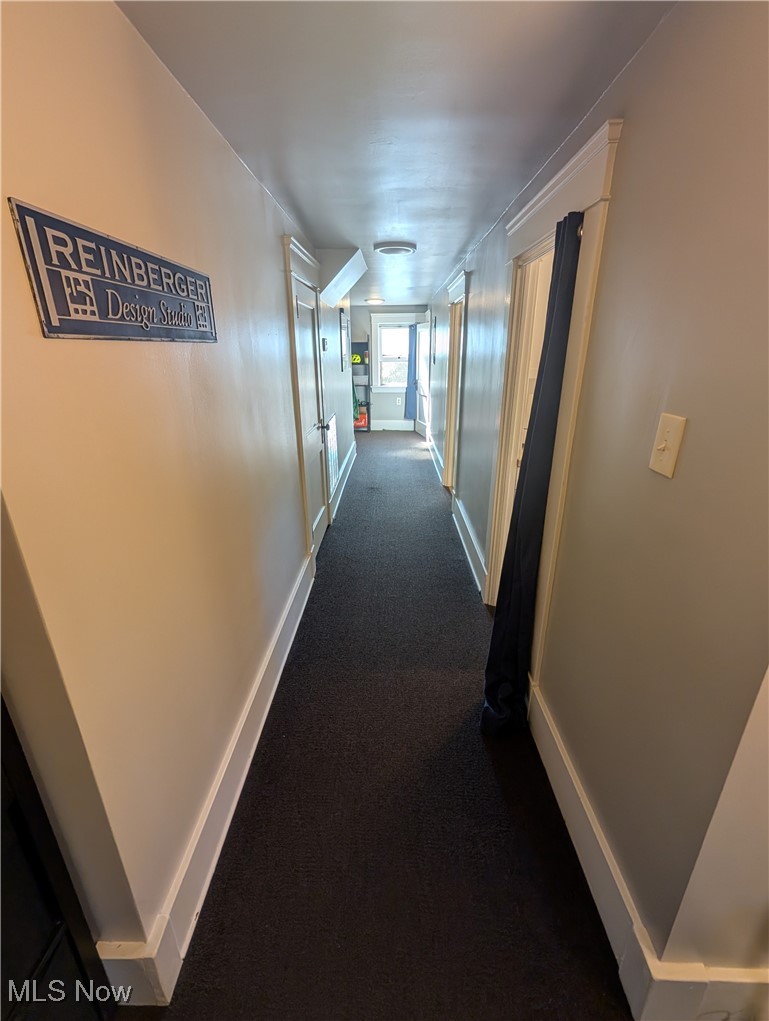 2108 Stillman Road, Unit 3 Cleveland, OH 44118 - Photo 12 of 14 Hallway with dark colored carpet and baseboards