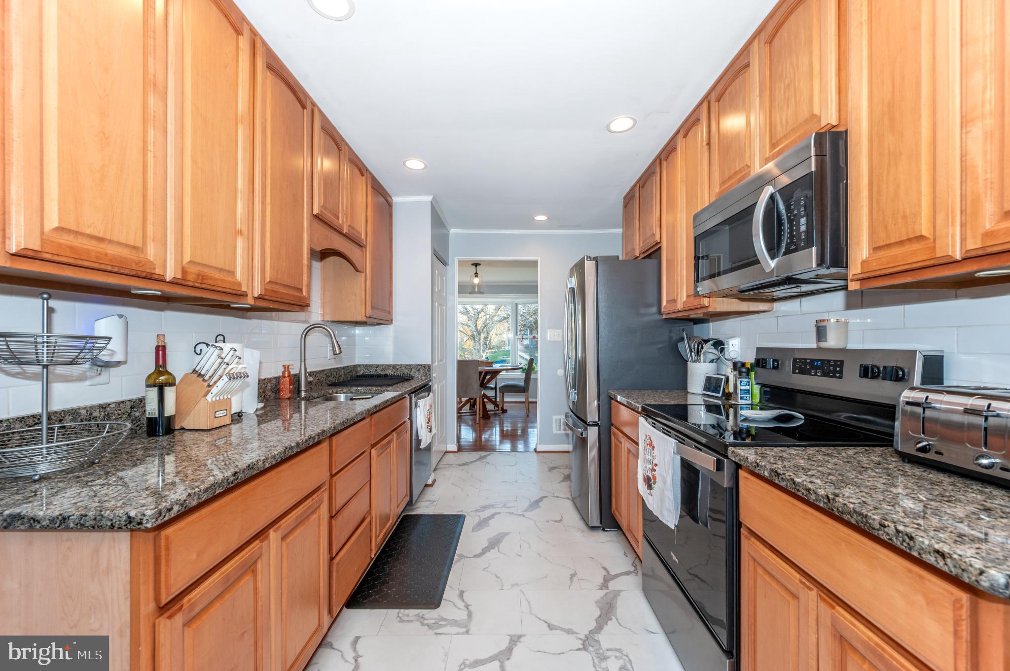 10453 Sweepstakes Road Damascus, MD 20872 - Photo 14 of 56 Modern kitchen with warm wood accents.