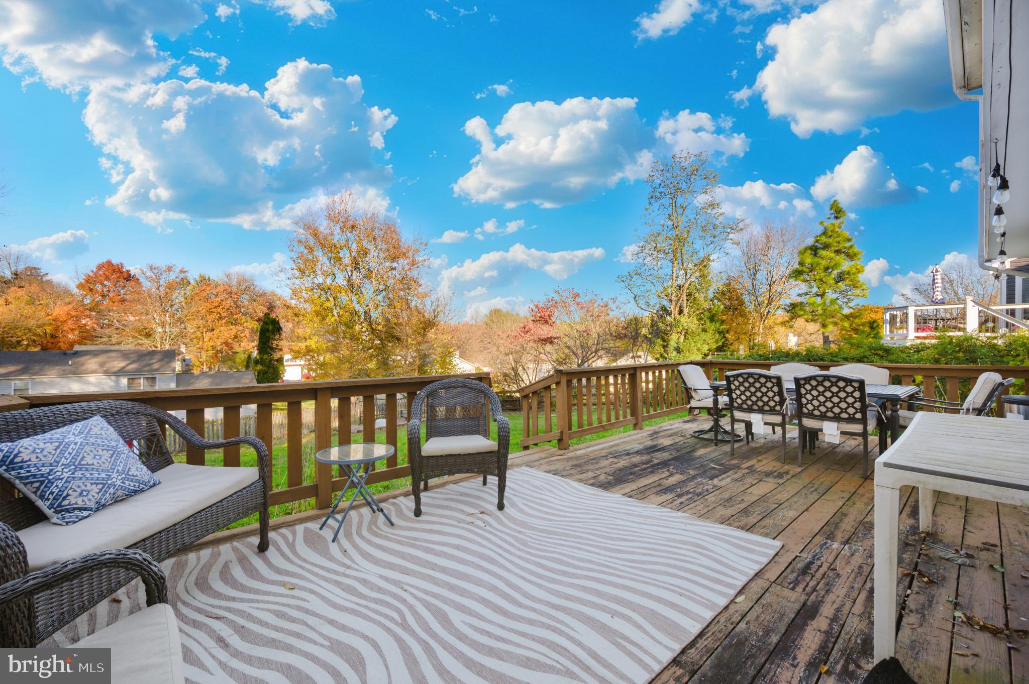 10453 Sweepstakes Road Damascus, MD 20872 - Photo 47 of 56 Serene deck with vibrant autumn backdrop.