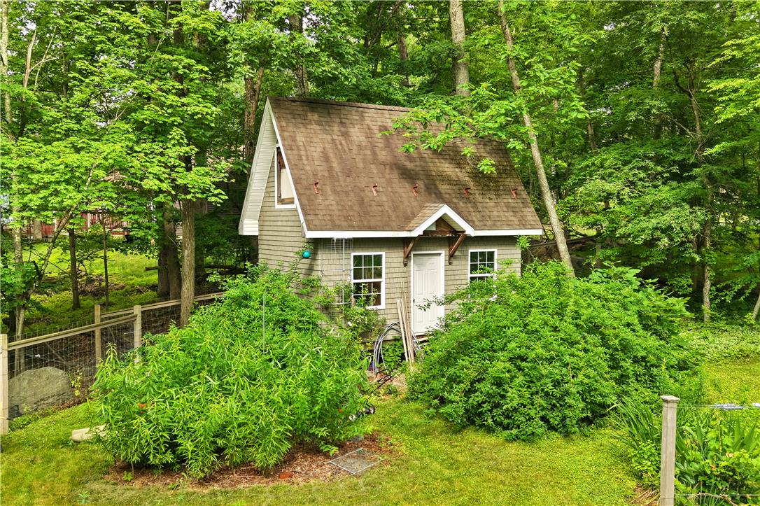 209 Remington Road East Stroudsburg, PA 18301 - Photo 34 of 41 A charming cottage nestled amongst verdant trees, offering a private, secluded escape.