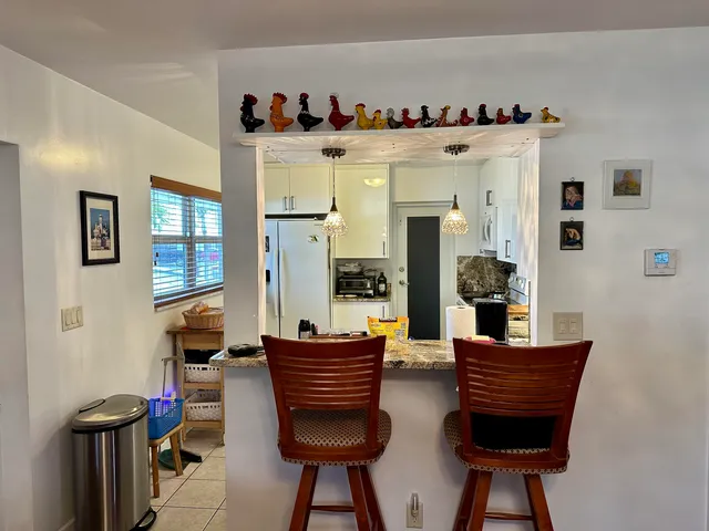 a view of a workspace with furniture and wooden floor