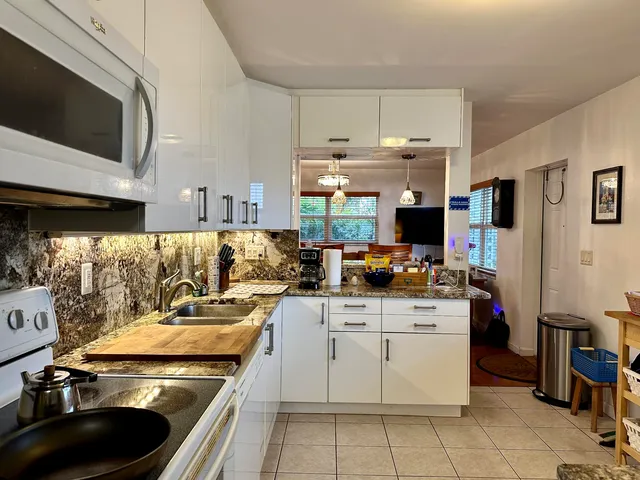 a front view of a house with garden and yard