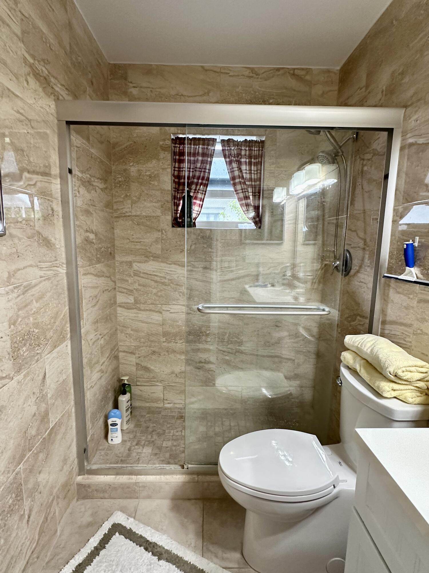 728 Ridge Road, Unit 35 Lantana, FL 33462 - Photo 10 of 35 a bathroom with a toilet and a shower