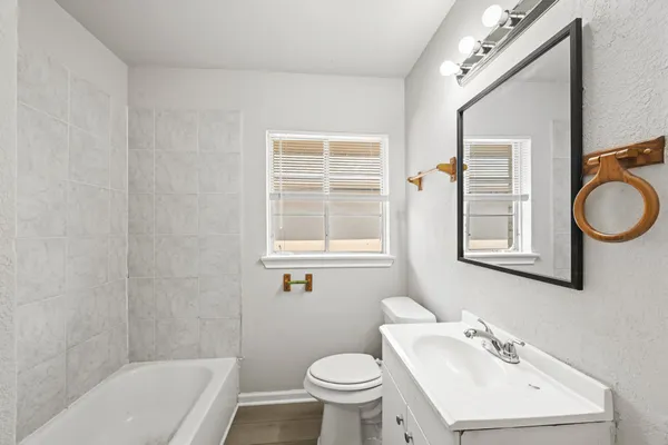 a bathroom with a sink a toilet and a bathtub