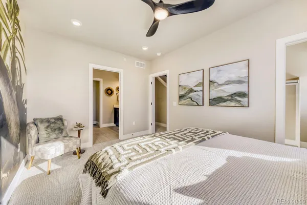 a bedroom with a large bed and a chandelier