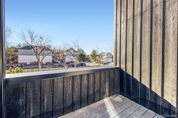a wooden deck with a trees in the background