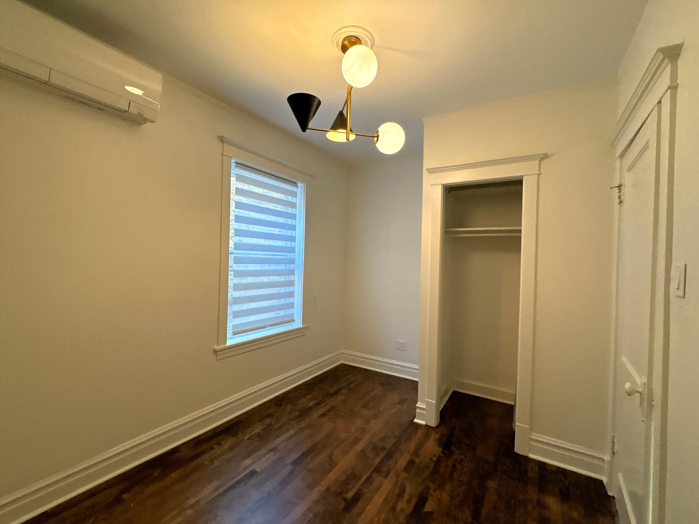 3078 North Davlin Court, Unit 2 Chicago, IL 60618 - Photo 12 of 19 a view of an empty room with wooden floor and a window