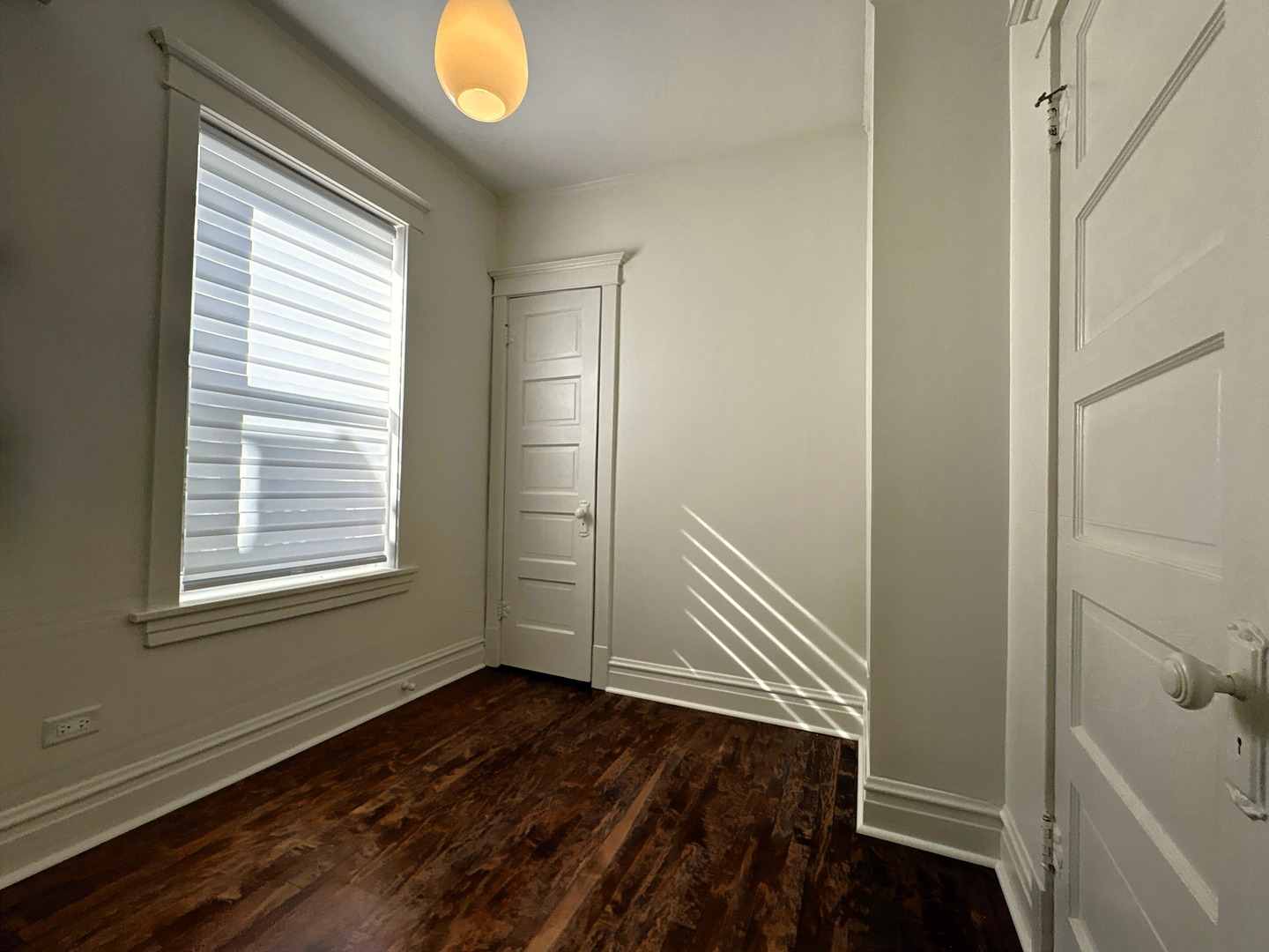 3078 North Davlin Court, Unit 2 Chicago, IL 60618 - Photo 15 of 19 a view of an empty room with wooden floor and a window