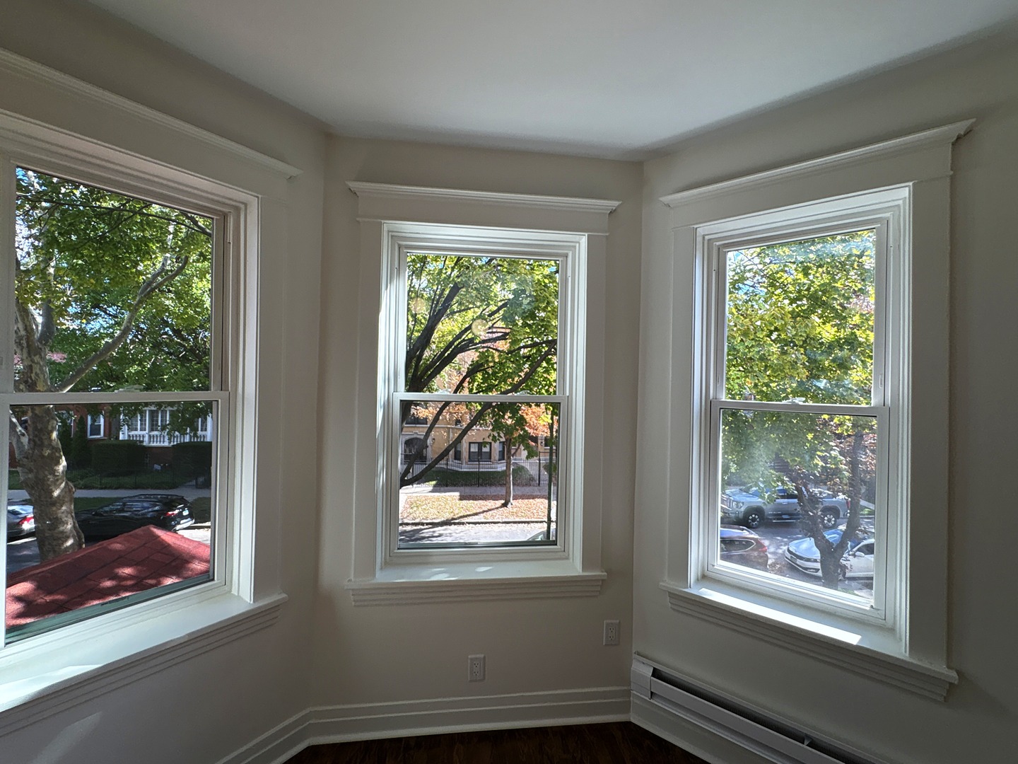 3078 North Davlin Court, Unit 2 Chicago, IL 60618 - Photo 2 of 19 a view of an empty room with wooden floor and a window