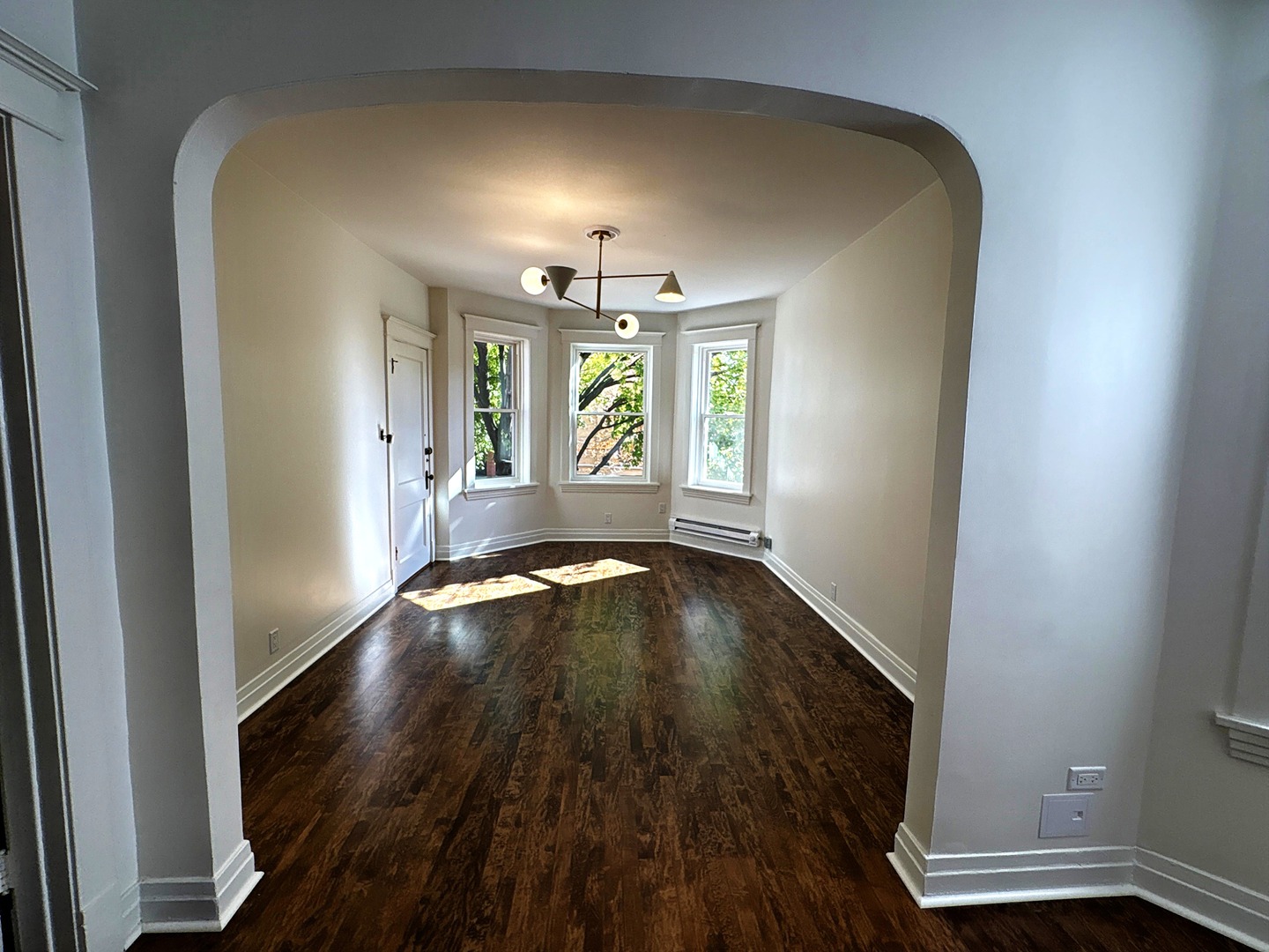 3078 North Davlin Court, Unit 2 Chicago, IL 60618 - Photo 3 of 19 wooden floor in an empty room with a window