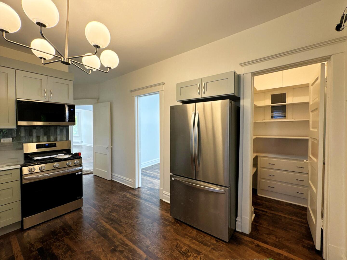 3078 North Davlin Court, Unit 2 Chicago, IL 60618 - Photo 6 of 19 a kitchen with a refrigerator stainless steel appliances and cabinets