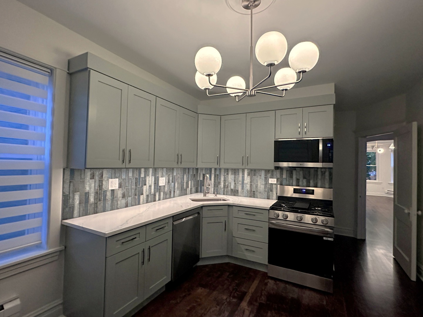 3078 North Davlin Court, Unit 2 Chicago, IL 60618 - Photo 7 of 19 a kitchen with a sink and cabinets