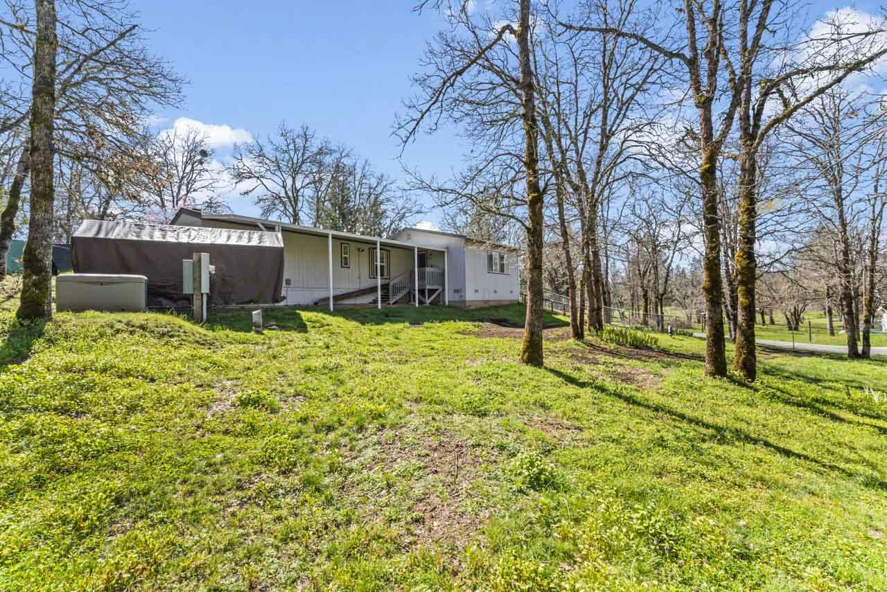 650 Three Pines Road Grants Pass, OR 97526 - Photo 11 of 48 a view of a house with a yard and tree