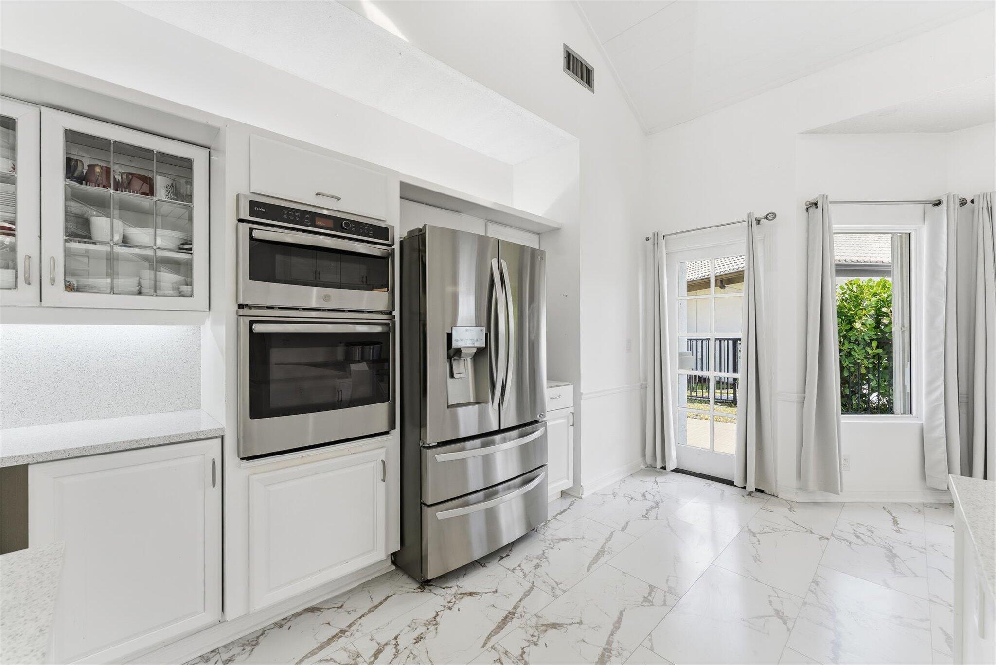 10722 Kirkaldy Lane Boca Raton, FL 33498 - Photo 14 of 76 a kitchen with stainless steel appliances and cabinets
