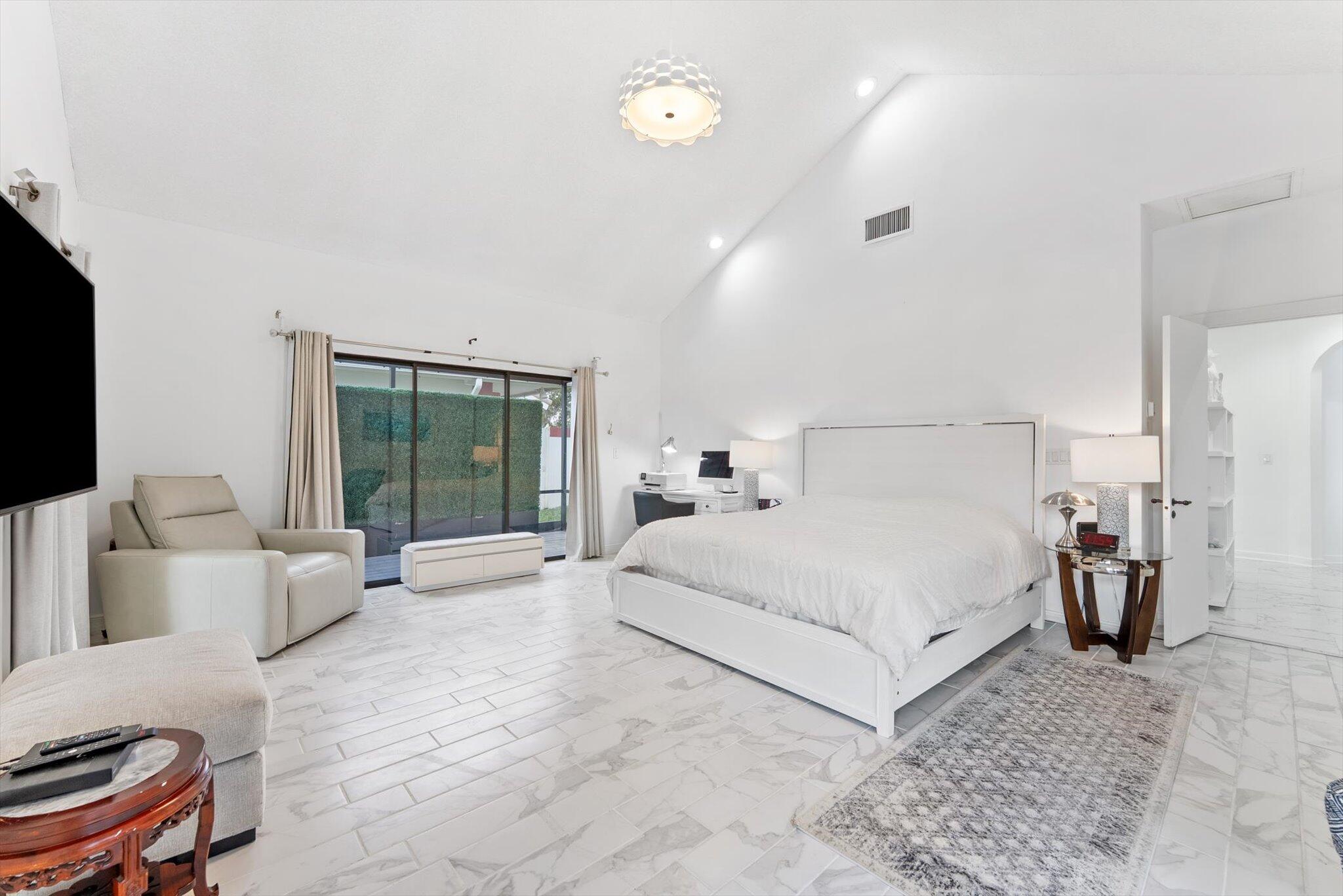 10722 Kirkaldy Lane Boca Raton, FL 33498 - Photo 20 of 76 a bedroom with a large bed and a couch