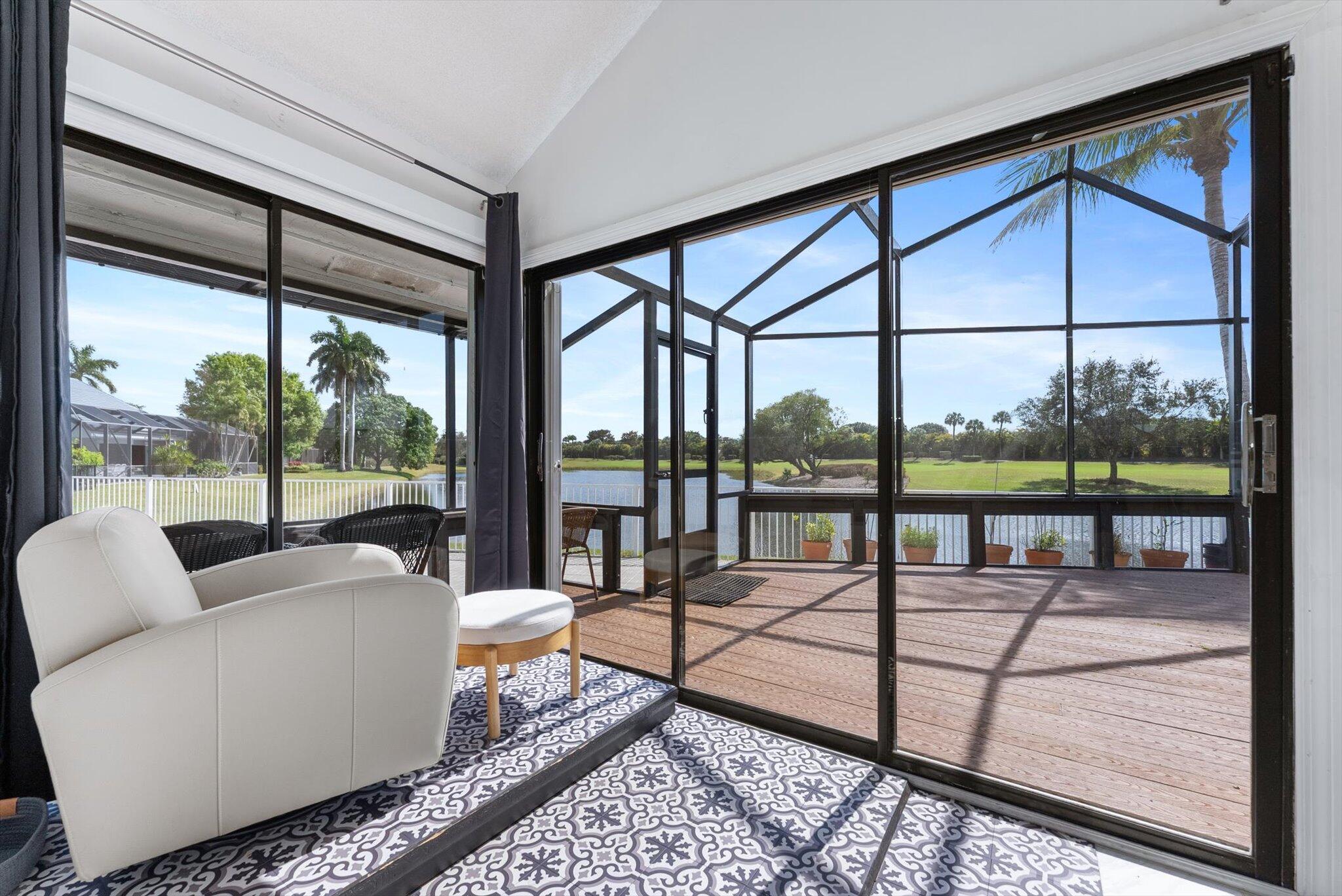 10722 Kirkaldy Lane Boca Raton, FL 33498 - Photo 23 of 76 a living room with a floor to ceiling window and table
