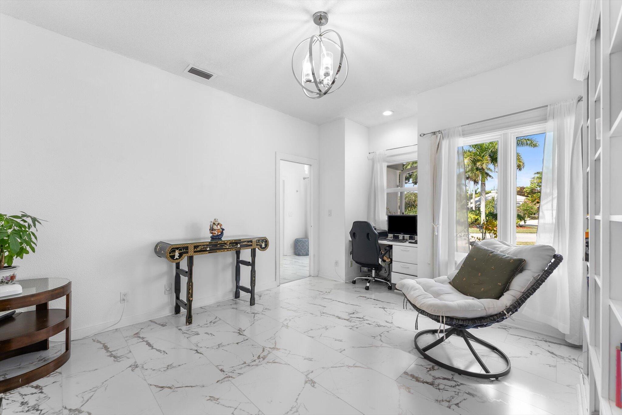 10722 Kirkaldy Lane Boca Raton, FL 33498 - Photo 26 of 76 a living room with furniture a window and a chandelier