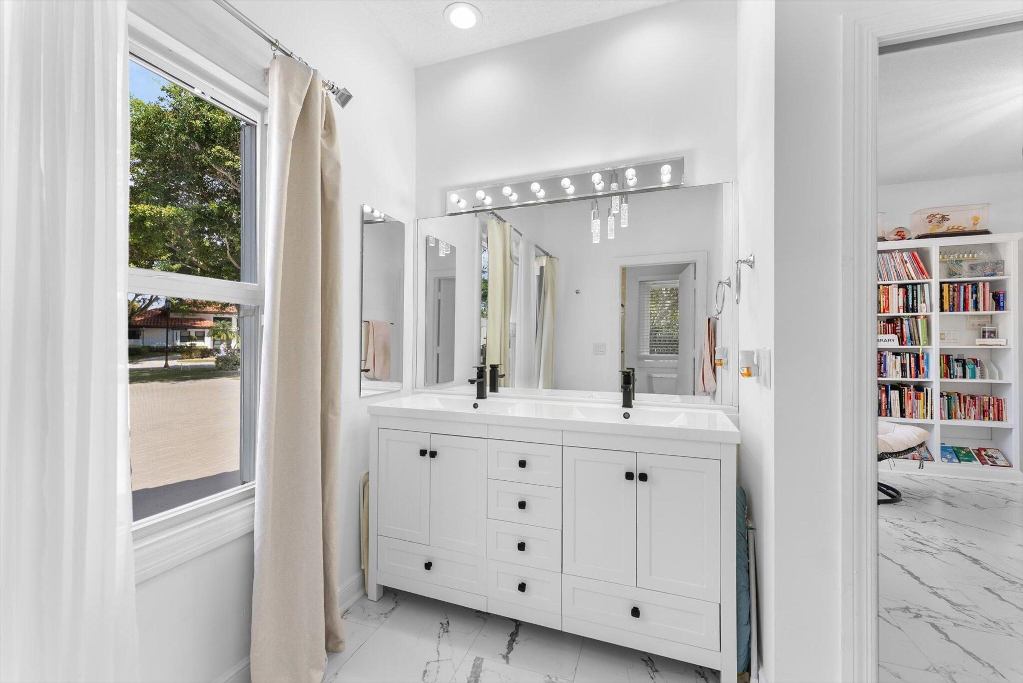 10722 Kirkaldy Lane Boca Raton, FL 33498 - Photo 27 of 76 a spacious bathroom with a double vanity sink and mirror