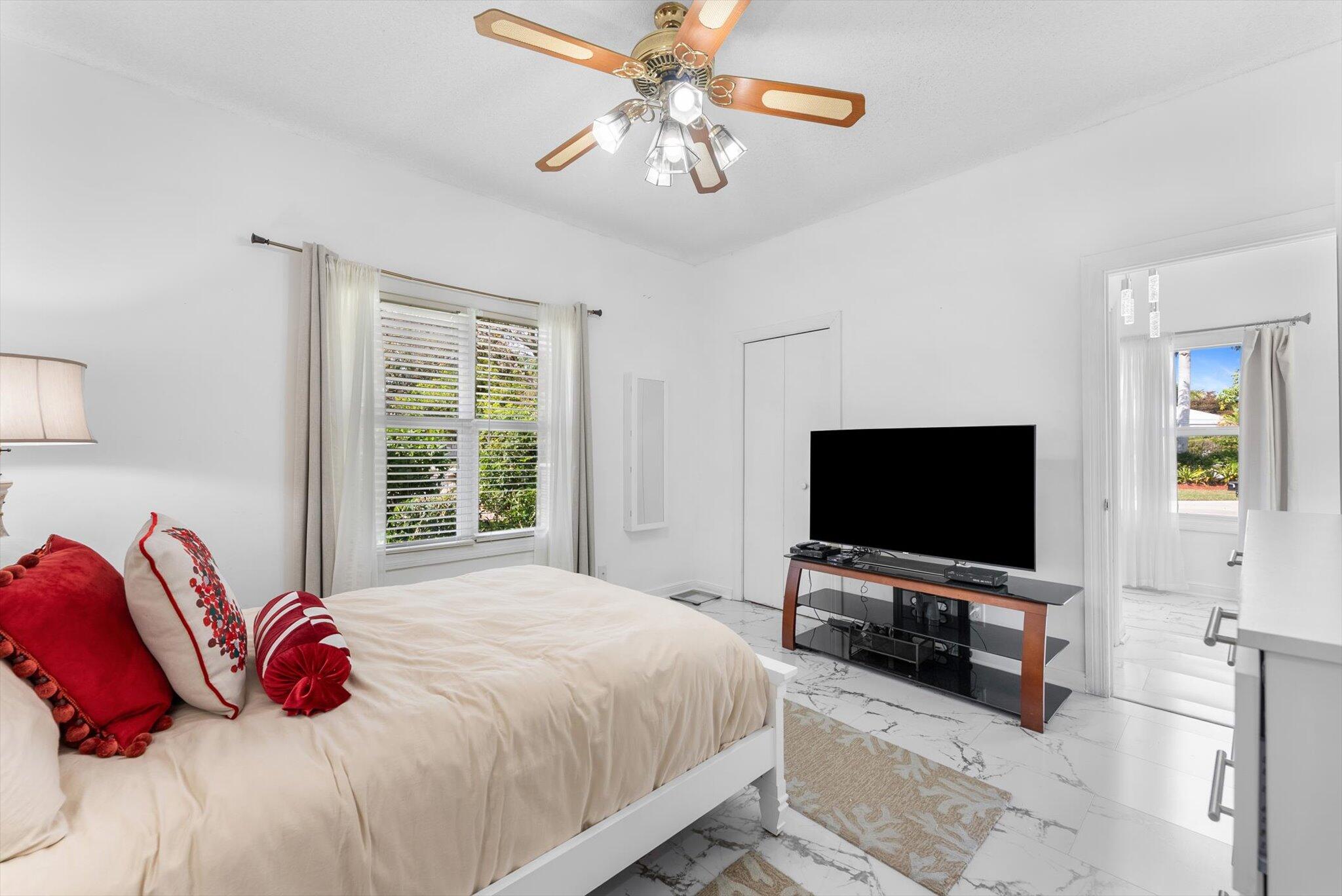10722 Kirkaldy Lane Boca Raton, FL 33498 - Photo 29 of 76 a bedroom with a bed and a flat screen tv