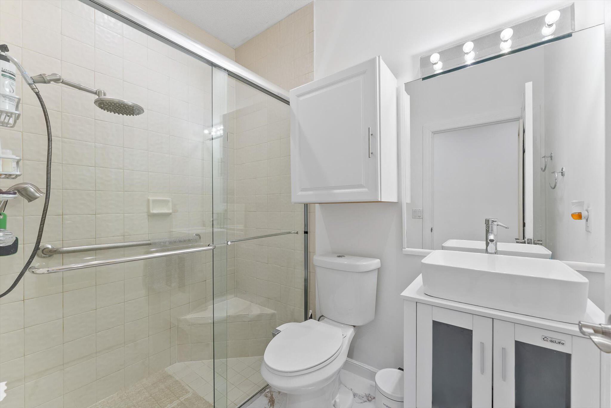 10722 Kirkaldy Lane Boca Raton, FL 33498 - Photo 35 of 76 a bathroom with a toilet sink and a mirror