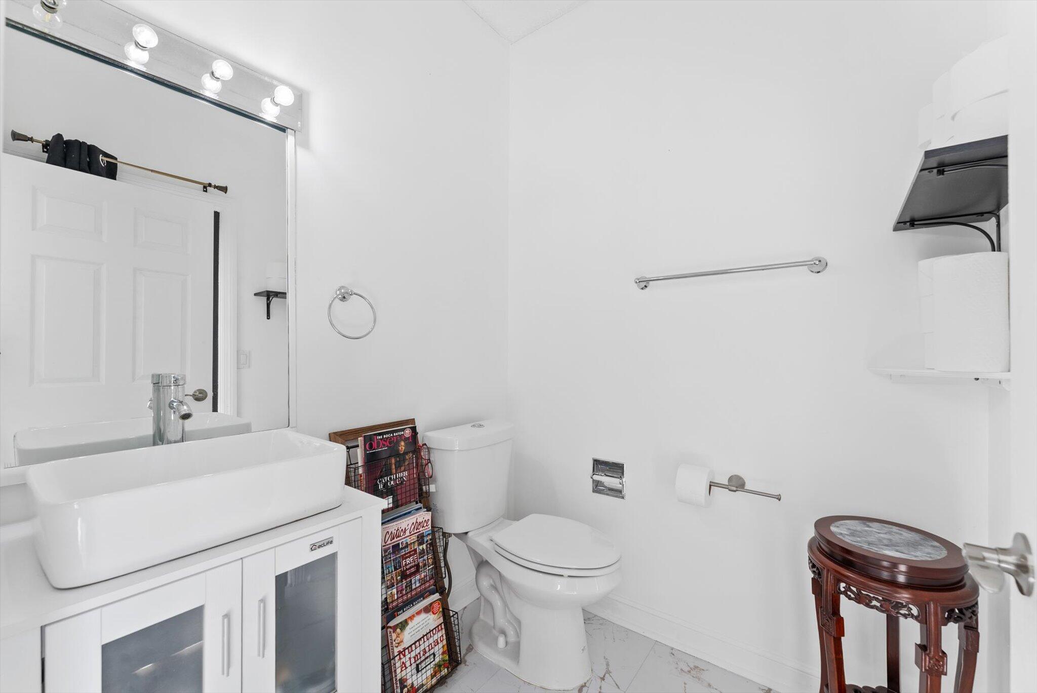 10722 Kirkaldy Lane Boca Raton, FL 33498 - Photo 37 of 76 a bathroom with a sink a toilet and a mirror