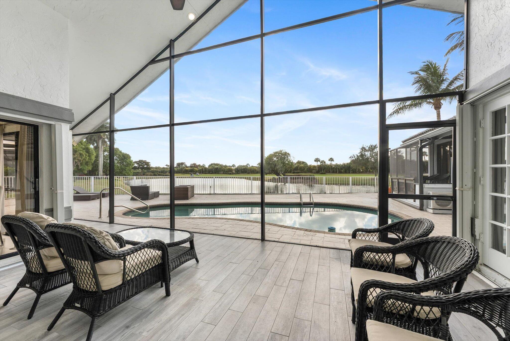 10722 Kirkaldy Lane Boca Raton, FL 33498 - Photo 39 of 76 a living room with furniture and a floor to ceiling window